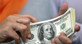 US Fed bows to market's more dovish view of soaring dollar