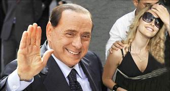 Scandal-hit Berlusconi to meet 'saintly' Dr Singh