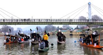 PICS: Houseboat owners stage floating protest in Srinagar