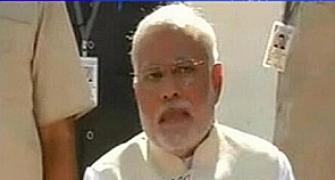 Modi in trouble with EC for flashing BJP symbol during presser