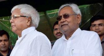 How does Nitish escape Lalu's boa constrictor-like embrace?
