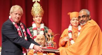 UK PM visits Hindu temple, vows to partner with Modi