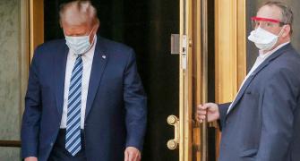 Trump returns to White House, removes mask for photos
