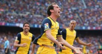 Atletico win La Liga title after draw at Barca