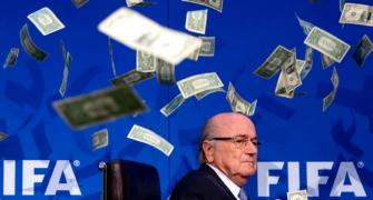 PHOTOS: Protester showers FIFA's Blatter with fake money