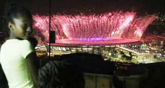 In favela above opening ceremony, pride and disappointment