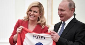 Croatian leader hands Putin soccer shirt before World Cup final