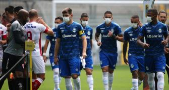 Brazilian team wear masks in protest at having to play