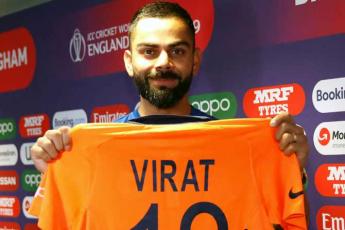 Captain Kohli gives thumbs-up to new orange jersey - Rediff.com