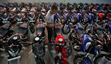 Motorcycles vroom past scooters on strong rural demand