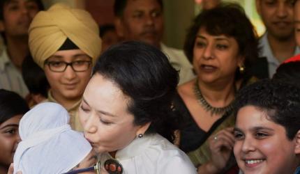 Sealed with a kiss: China's First Lady has all in smiles at Delhi school