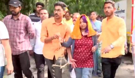 Daughter in blood-stained clothes leads victim's funeral