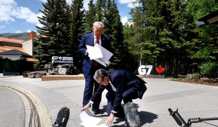 Why Is Britain's PM At Trump's Feet?