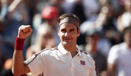 Federer earns milestone; Nadal powers past Goffin