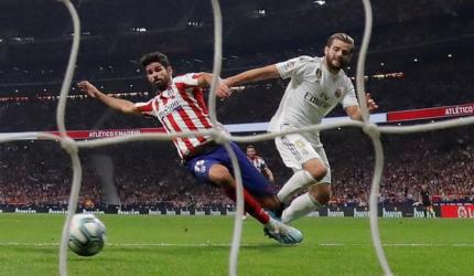 Real Madrid top La Liga after derby draw at Atletico