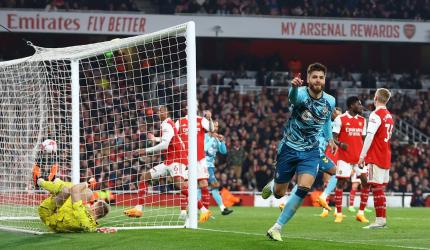 PICS: Arsenal stage late escape, but title hopes hit