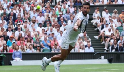 PIX: Djokovic hits century, leads veterans into last 16