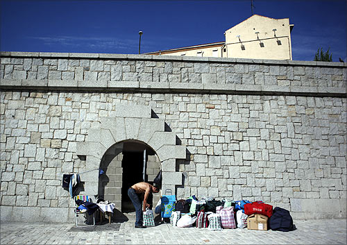 Paco, 59, pack his belongings as he is evicted from his home, a small opening on a wall adjacent to Madrid's Toledo bridge.