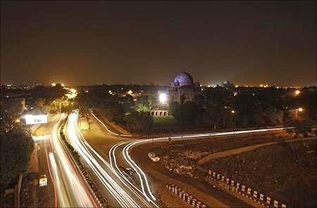 Traffic moves along a busy road after electricity was restored in New Delhi.