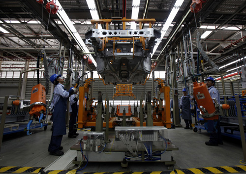 Employees work at an assembly line in the new Ford Thailand manufacturing plant located in Rayong province, East of Bangkok.