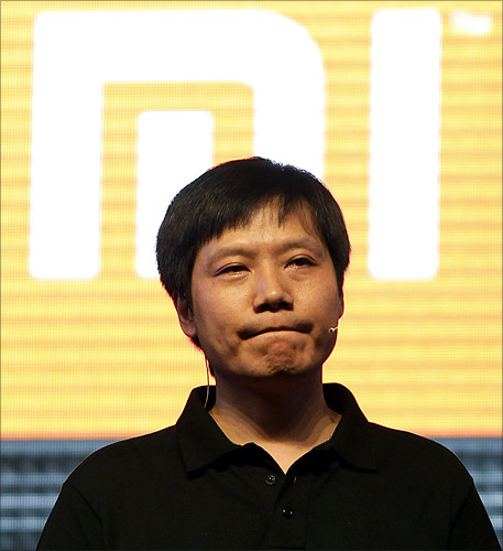Lei Jun, founder and CEO of China's mobile company Xiaomi, pauses in front of his company's logo at a launch ceremony of Xiaomi Phone 2 in Beijing.
