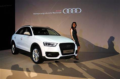 A model stands near a new Audi Q3 during its launch in Jakarta.