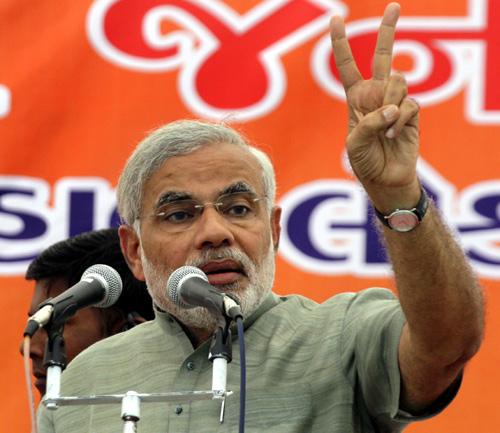 Gujarat's Chief Minister Narendra Modi gestures during an election campaign rally in Balasinor.