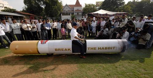 Indian car designer K. Sudhakar drives a cigarette shaped motorcycle in Hyderabad.