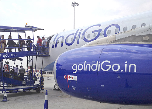 Passengers disembark from an IndiGo Airlines A320 aircraft at Bengaluru International Airport in Bangalore.