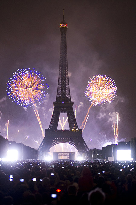 Eiffel Tower is illuminated during the traditional Bastille Day fireworks display in Paris.
