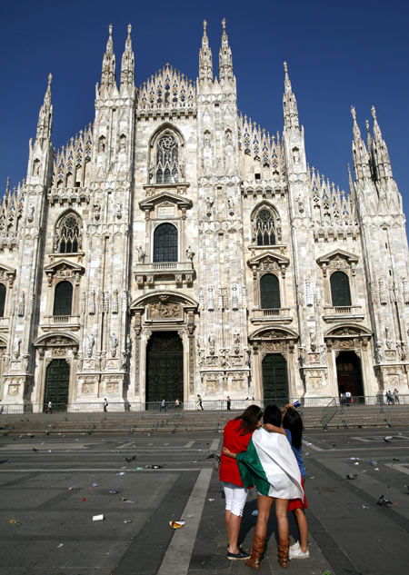 Italian soccer fans react at Duomo's square in Milan.