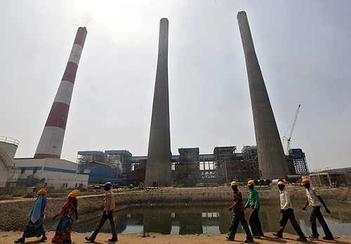 Workers walk inside the Jindal Power and Steel Ltd. complex at Nisha village in Orissa.