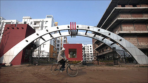 A man cycles past residential apartments in Patna.