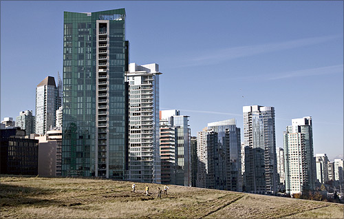 Landscapers groom the grass after it was given its annual mowing on the roof of the Vancouver Convention Centre in Vancouver.