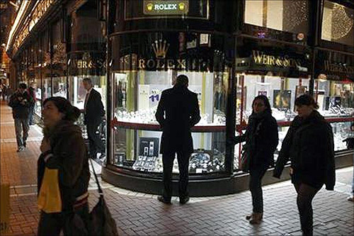 A man looks at a window display of jewellery on Grafton Street, Dublin.