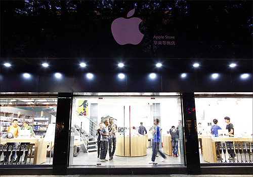 Customers and employees are seen from the exterior of a fake Apple Store in Kunming, Yunnan province.