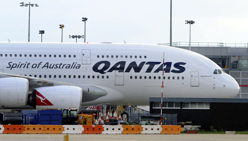 A grounded Qantas aircraft is seen parked at Heathrow Airport in west London.