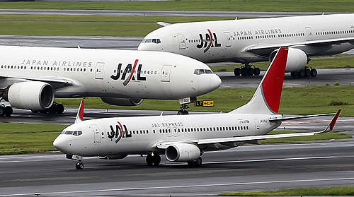 Japan Airlines (JAL) aircrafts are seen on the tarmac at Haneda airport in Tokyo.