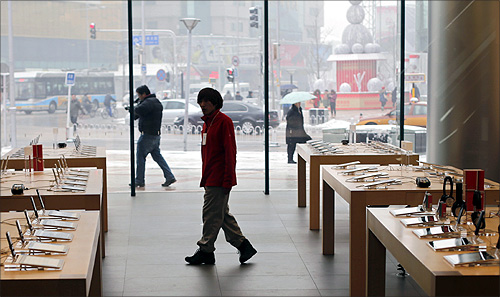 A staff walks inside an Apple store during the release of iPhone 5 in Beijing's Wangfujing shopping district.
