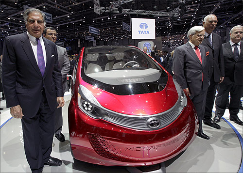 Tata Motors' Chairman Ratan Tata (L) poses in front of the Megapixel model car during the first media day of the Geneva Auto Show at the Palexpo in Geneva.