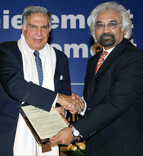 Ratan Tata, chairman of the Tata Group, receives the lifetime achievement award for management from Sam Pitroda, advisor to the Prime Minister of India on public information, infrastructure and innovation, conferred by the All India Management Association in 2011.