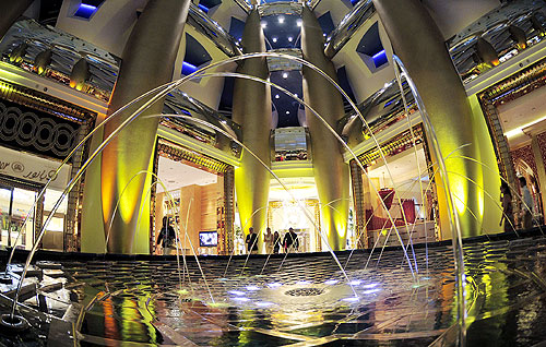 Guests walk past one of the fountains at the Burj Al Arab hotel in Dubai.