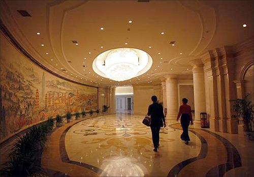 Guests walk in the lobby of the new skyscraper tower of Huaxi village before its official inauguration in Jiangsu province.