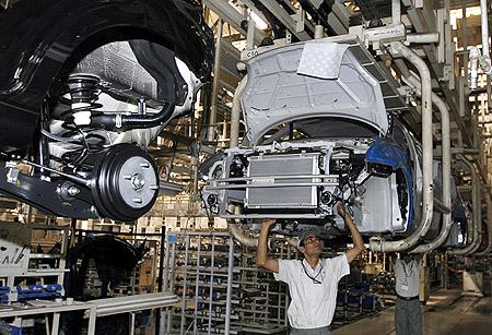 ers assemble a car at a Maruti Suzuki plant in Manesar.