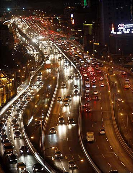 Vehicles drive during the evening rush hour in central Shanghai.