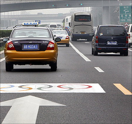 Vehicles past along a special Olympic lane at an airport expressway in Beijing.