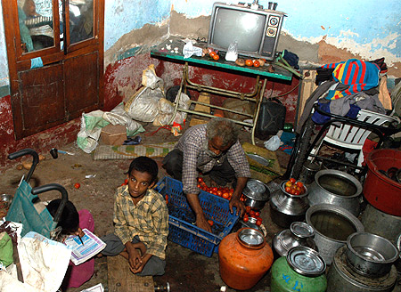 Vasim Khan (L), a 10-year-old polio victim, sits with his father Abdul Rasheed in their house in the southern Indian city of Bangalore.