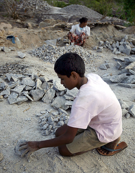 A boy and his mother break pieces of granite in a quarry in the remote village of Thumbalai, 300km (186 miles) east of Colombo.