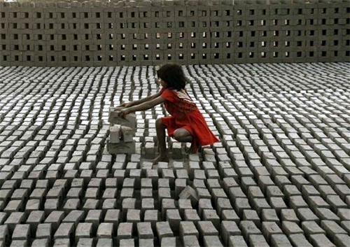 A child-labourer works inside a brick factory on the outskirts of Hyderabad.