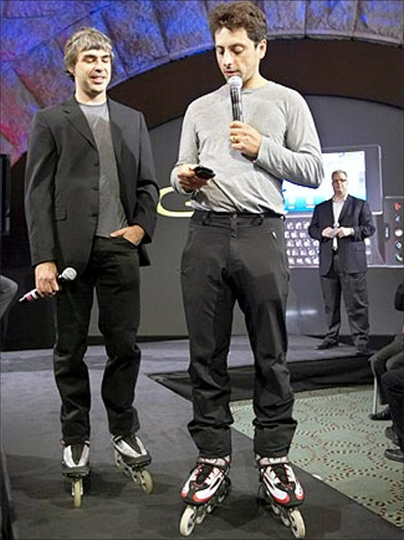 Larry Page (left) and Sergey Brin, founders of Google, show the new G1 phone running Google's Android software.